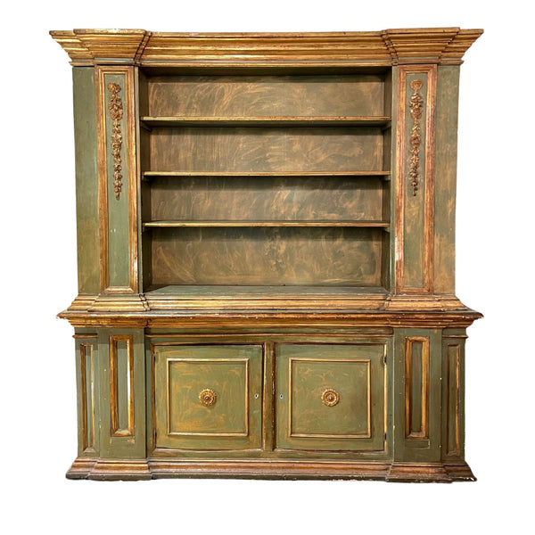 Antique handcarved Italian cabinet with shelving and gold trims.this bookcase offers ample space for your favorite volumes and decorative items. The intricate carving work showcases the craftsmanship of an Italian master, while the gold finishing adds a luxurious touch.